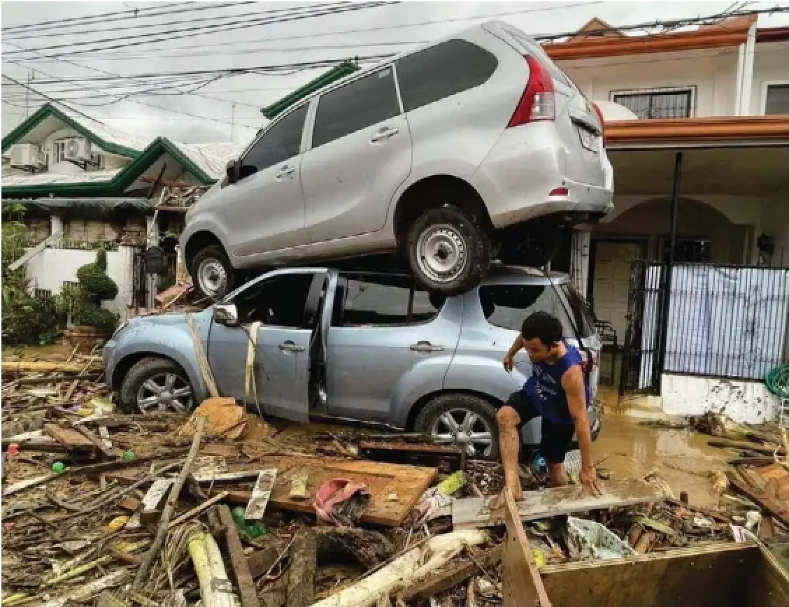 A man makes his way through debris after Typhoon Kalmaegi hit Cebu city, central Philippines, Tuesday. The area was still recovering from a 6.9magnitude earthquake in September that left at least 79 people dead and displaced thousands.