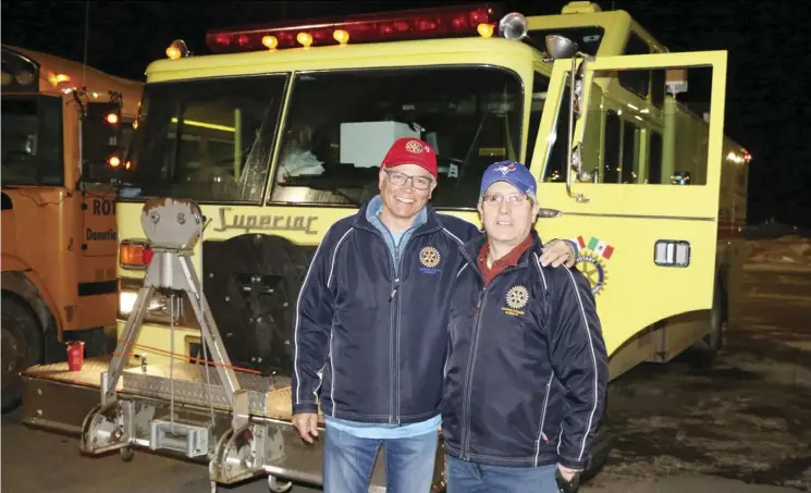 Grand Prairie Ro­tarians Felix Seiler, left, and Rick Con­rad with a fire truck that will be driven to Mazat­lan, Mex­ico.