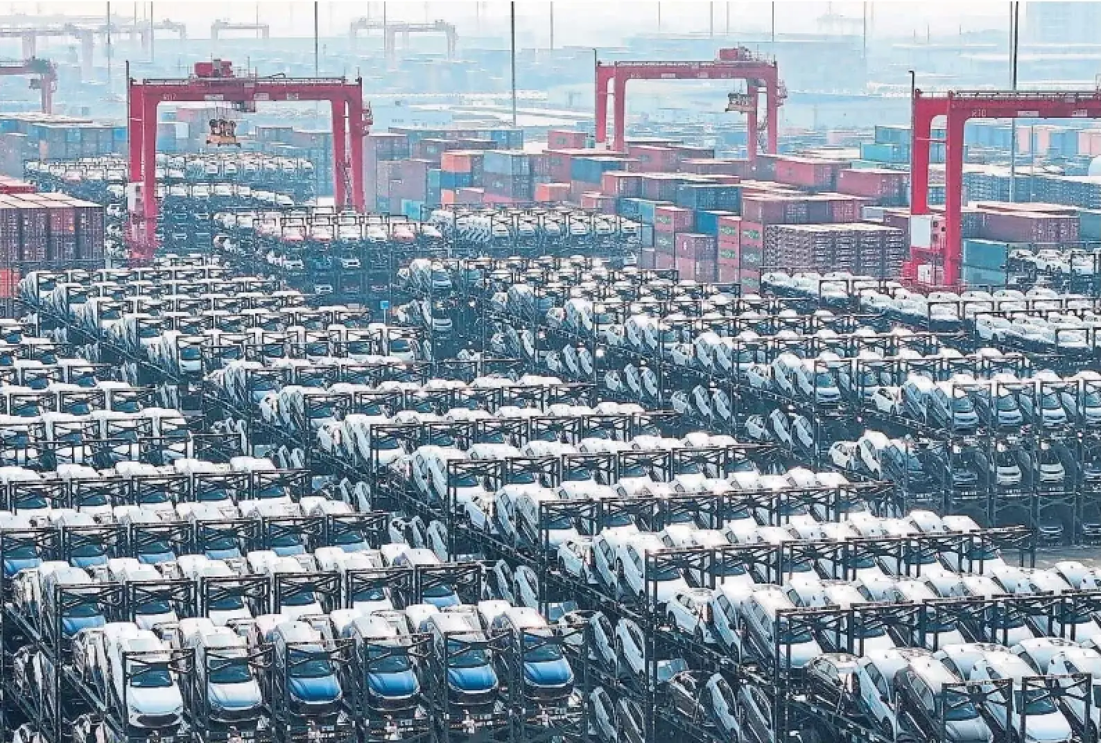 BYD electric vehicles are prepared to be loaded onto a ship in China. Canada's 100 per cent tariff on Chinese electric vehicles faces an automatic review due by Oct. 1.
