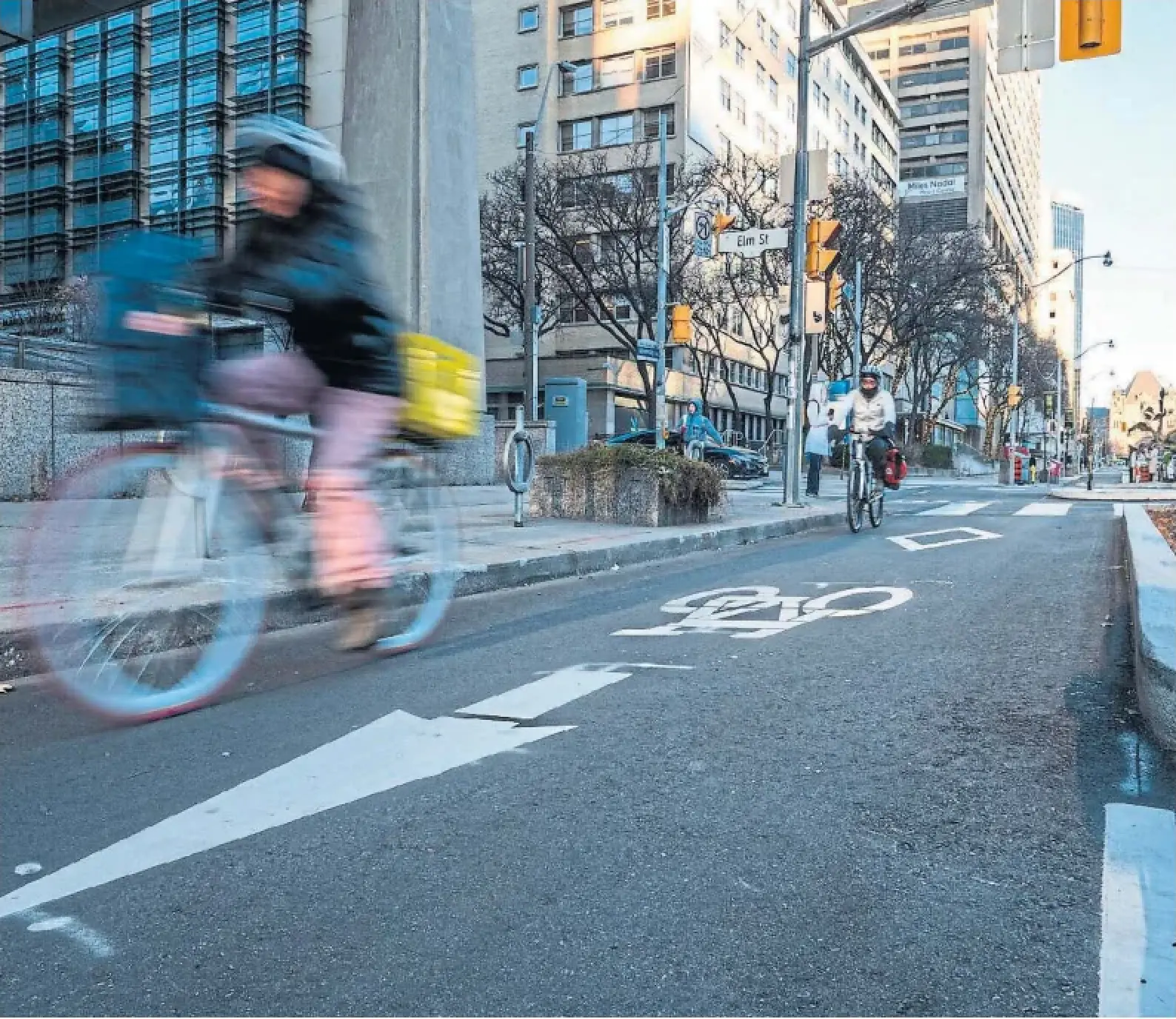 A cyclist rides in a University Avenue bike lane targeted for demolition by the Ford government. Lanes on Yonge Street and Bloor Street West are also on the list for removal, along with, according to sources, Queen's Park Crescent and Avenue Road.