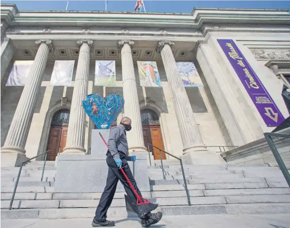 An em­ployee cleans the steps of the Mon­treal Mu­seum of Fine Arts.