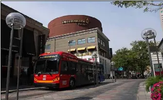 An RTD free mall ride bus makes its way through a mostly empty 16th Street Mall on Oct. 2 in down­town Den­ver.