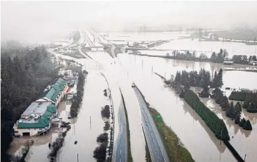 Floodwaters cover a portion of Highway 1 in Abbotsford, B.C., on Friday. The province said Sunday the highway was reopened, but officials warned there could be “short notice” closures on some stretches.