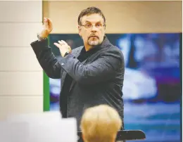 Mu­sic di­rec­tor Richard Stoelzel puts the Lakeshore Con­cert Band through its paces dur­ing a re­cent re­hearsal.