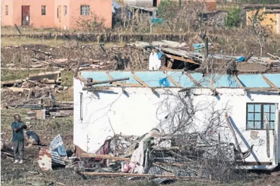 A man salvages belongings from his flooddamaged house in Mthatha, South Africa, on Friday. At least 86 people have died in the floods, and officials say the death toll could rise further.