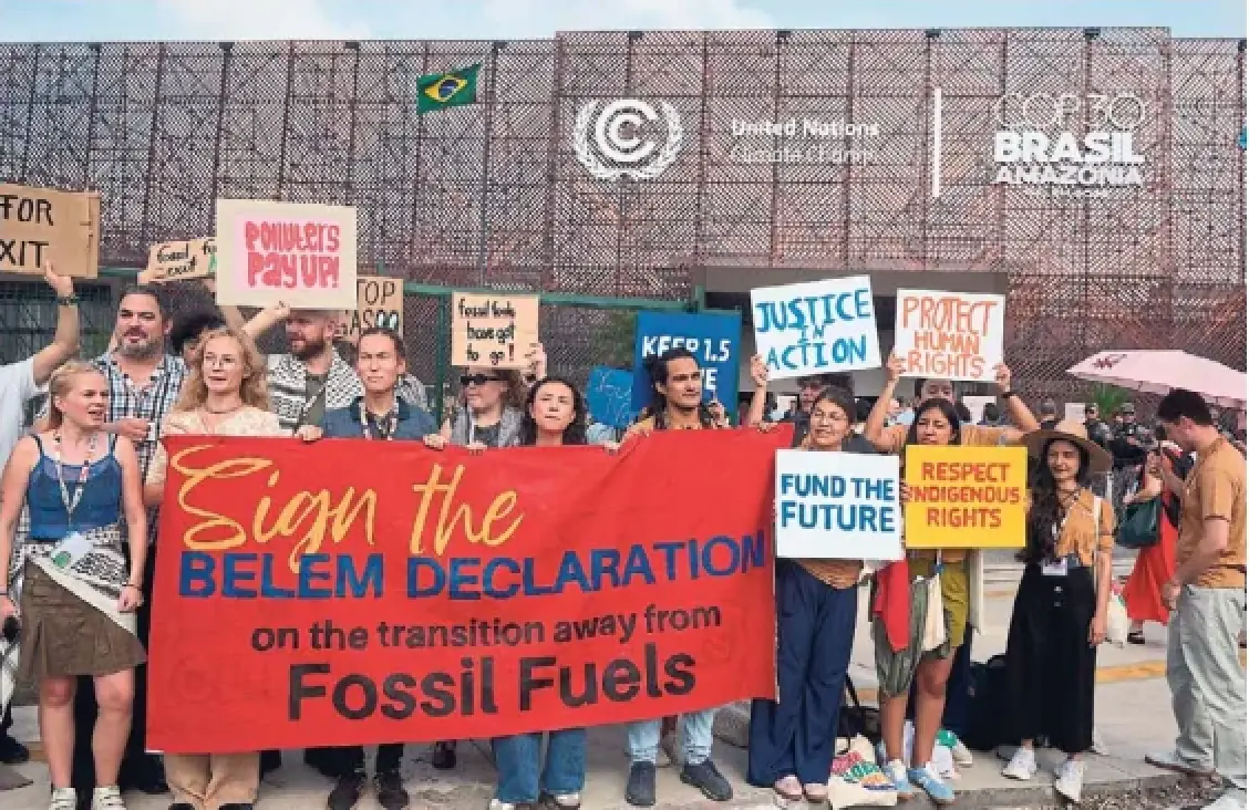 Activists push for a transition away from fossil fuels outside the venue for the COP30 UN Climate Summit in Belém, Brazil, on Wednesday. Two years ago, climate talks agreed to language calling for a transition away from fossil fuels, but little has been done since to clarify or amplify on that one sentence.