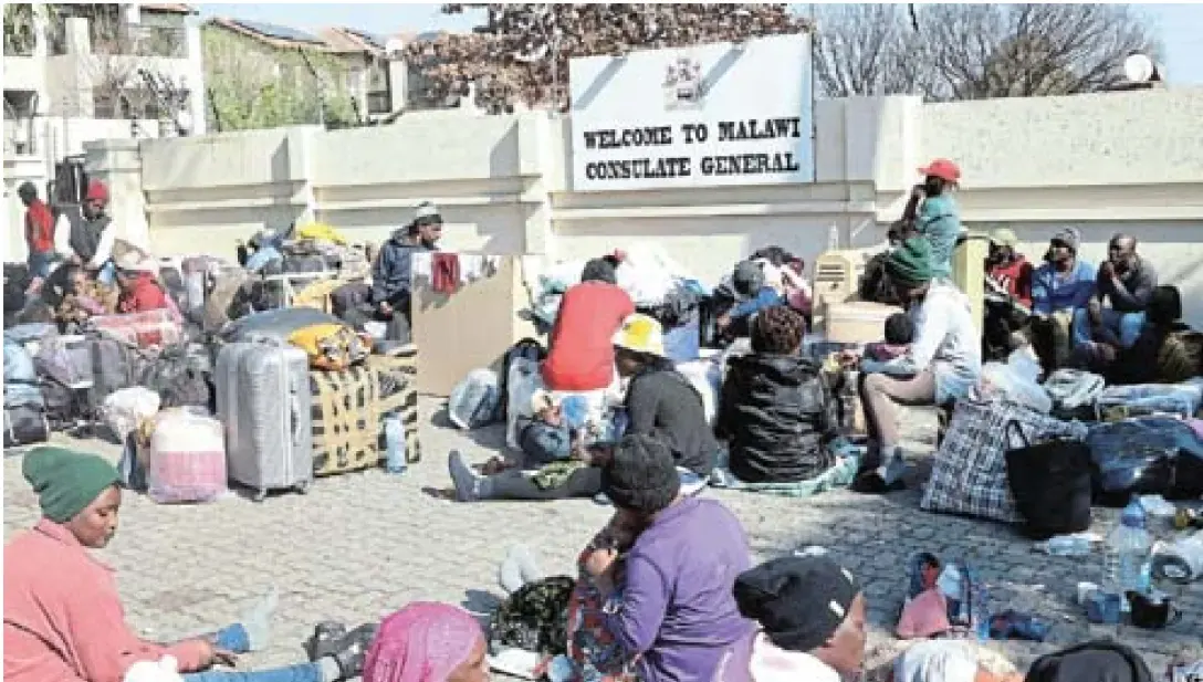 About 261 Malawian nation­als, includ­ing 31 chil­dren, gathered out­side their con­su­late after decid­ing to leave South Africa.