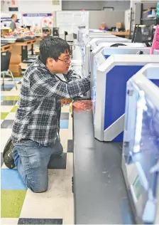 UTC grad­u­ate Chantz Yanagida is in charge of main­tain­ing and re­pair­ing the 62 3D print­ers be­ing used to make trans­par­ent face shields for health-care work­ers. The print­ers run sev­eral hours a day at Hamil­ton County’s STEM School at Chat­tanooga State Com­mu­nity Col­lege.