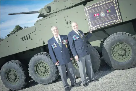 Jim Jenk­ins (left), Royal Cana­dian Le­gion Branch 95 pres­i­dent, and Keith An­der­son, Royal Cana­dian Le­gion Branch 95 ser­vice of­fi­cer, with the new LAV that is on dis­play in Smiths Falls as a memo­rial for Afghanistan vet­er­ans.