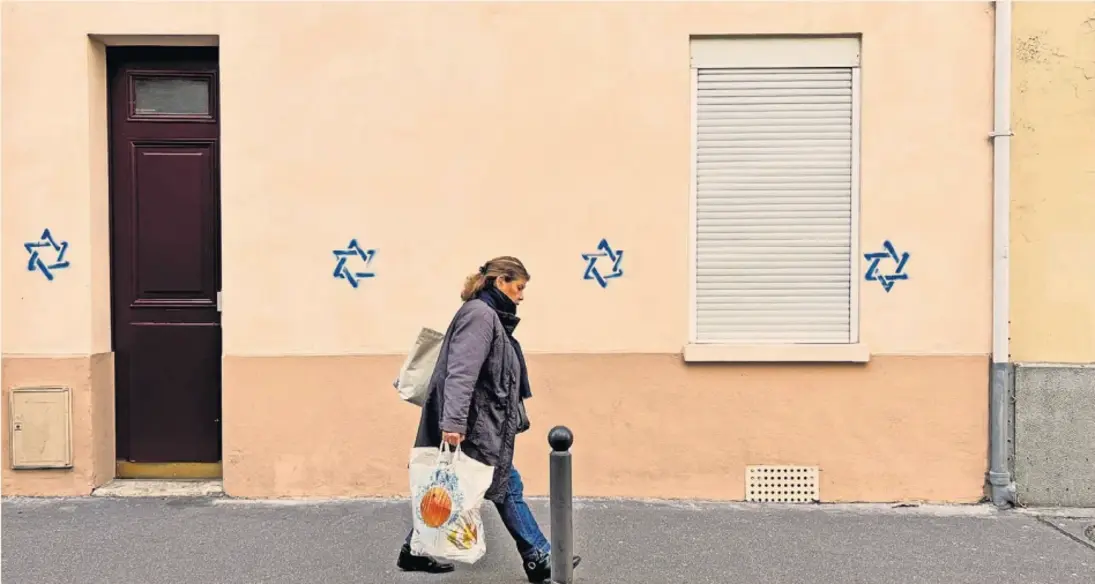 Divisive: Star of David graffiti in Paris, allegedly painted in support of Jews but used by Russian-linked websites to split French society
