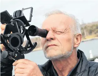 Ed­ward Wa­len­tynow­icz demon­strates a sex­tant he will be us­ing to nav­i­gate the world's oceans in the Golden Globe Race.