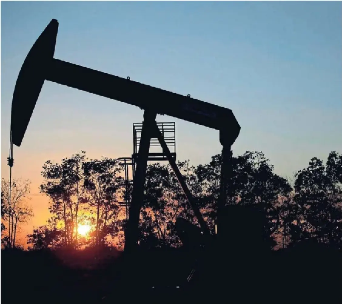 The sun sets behind an oil well in Venezuela in 2015. The chief concern for Canada is that Venezuelan oil could surge onto the global market, sinking an already weak world oil price at the expense of Canadian oil producers, David Olive writes.