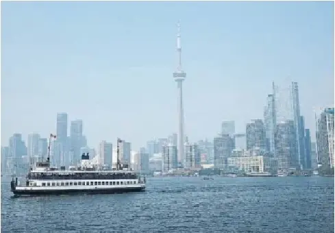 A ferry pre­pares to dock Monday at Centre Island. Sev­eral camps received calls from par­ents ask­ing that their chil­dren be lim­ited to indoor activ­it­ies.