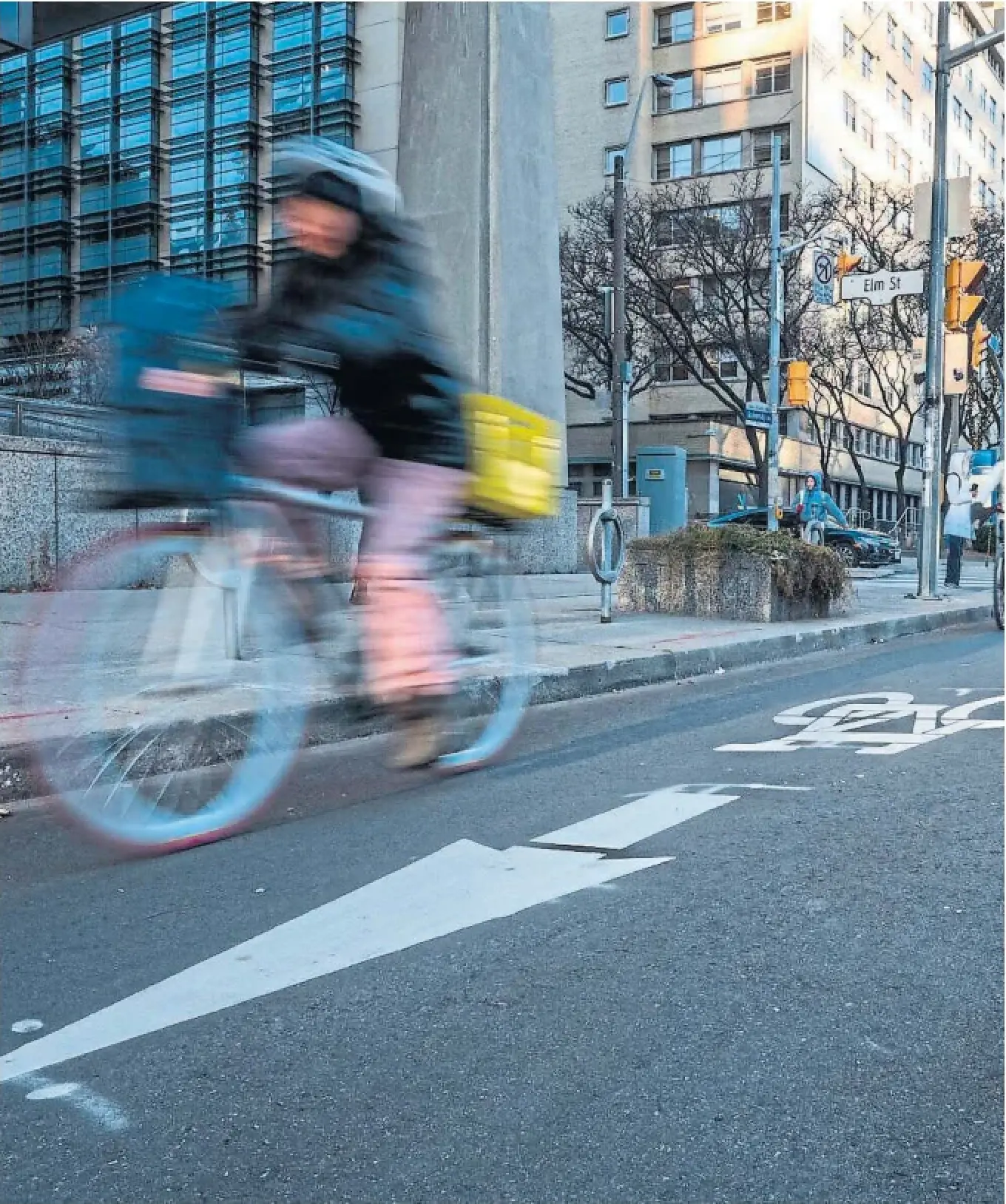 A cyclist rides in a bike lane on University Avenue last December.