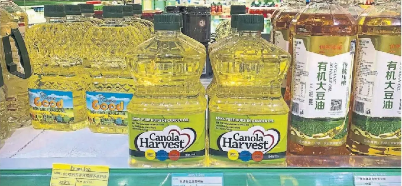 Bottles of canola oil manufactured in Canada are seen on a shelf of a grocery store in Beijing. C hina has imposed a 100 per cent retaliatory tariff on certain canola products from Canada.