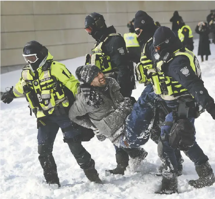 Police take a demonstrator into custody in Ottawa in February 2022 using powers granted by the Emergencies Act, legislation the Federal Court of Appeal has affirmed was invoked illegally.